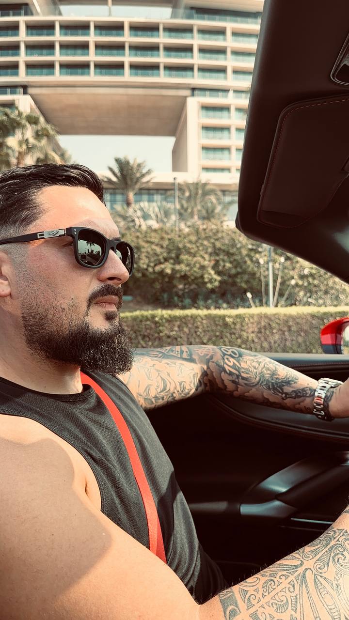 Ionut wearing sunglasses in a convertible